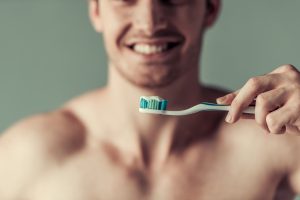 Man holding dental tooth brush for brushing tooth